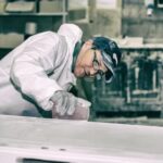 Should I Woodwork Indoors Image: Person contemplating woodworking indoors with a variety of tools and materials