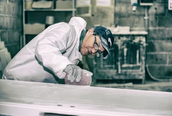 Image: Person contemplating woodworking indoors with a variety of tools and materials