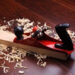 Image showing a woodworker using woodworking tools and creating a wooden masterpiece