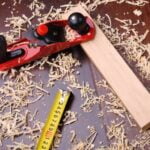 What Is a Lathe in Woodworking Image: A lathe in woodworking with a wooden log being turned and shaped