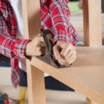 Did the Woodworker Find the Book Woodworker finding the book in workshop filled with tools and sawdust