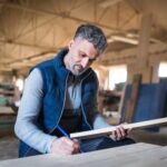 Woodworking Indoors Skilled craftsman creating furniture indoors: WOODWORKING INDOORS