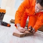 Photo of Mark Hammond woodworking and smiling happily while surrounded by wood shavings