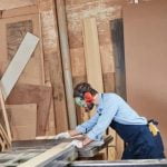 Woodworking router being used to shape or create intricate designs on wooden surfaces